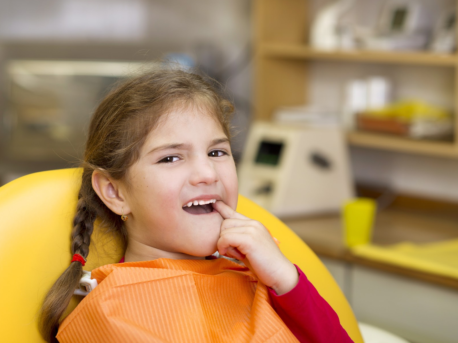 Child smiling during an early orthodontic evaluation for braces in Franklin, NC.